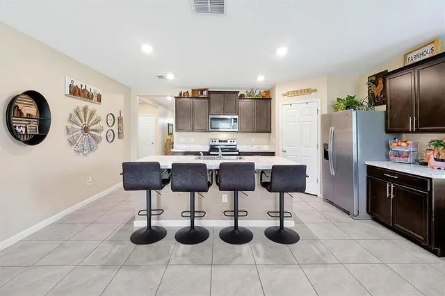 a kitchen with stainless steel appliances kitchen island granite countertop a sink and cabinets