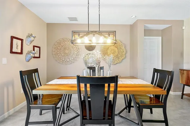 a view of a dining room with furniture and chandelier