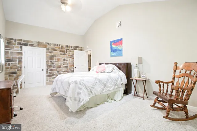 a bed room with a bed and a chair