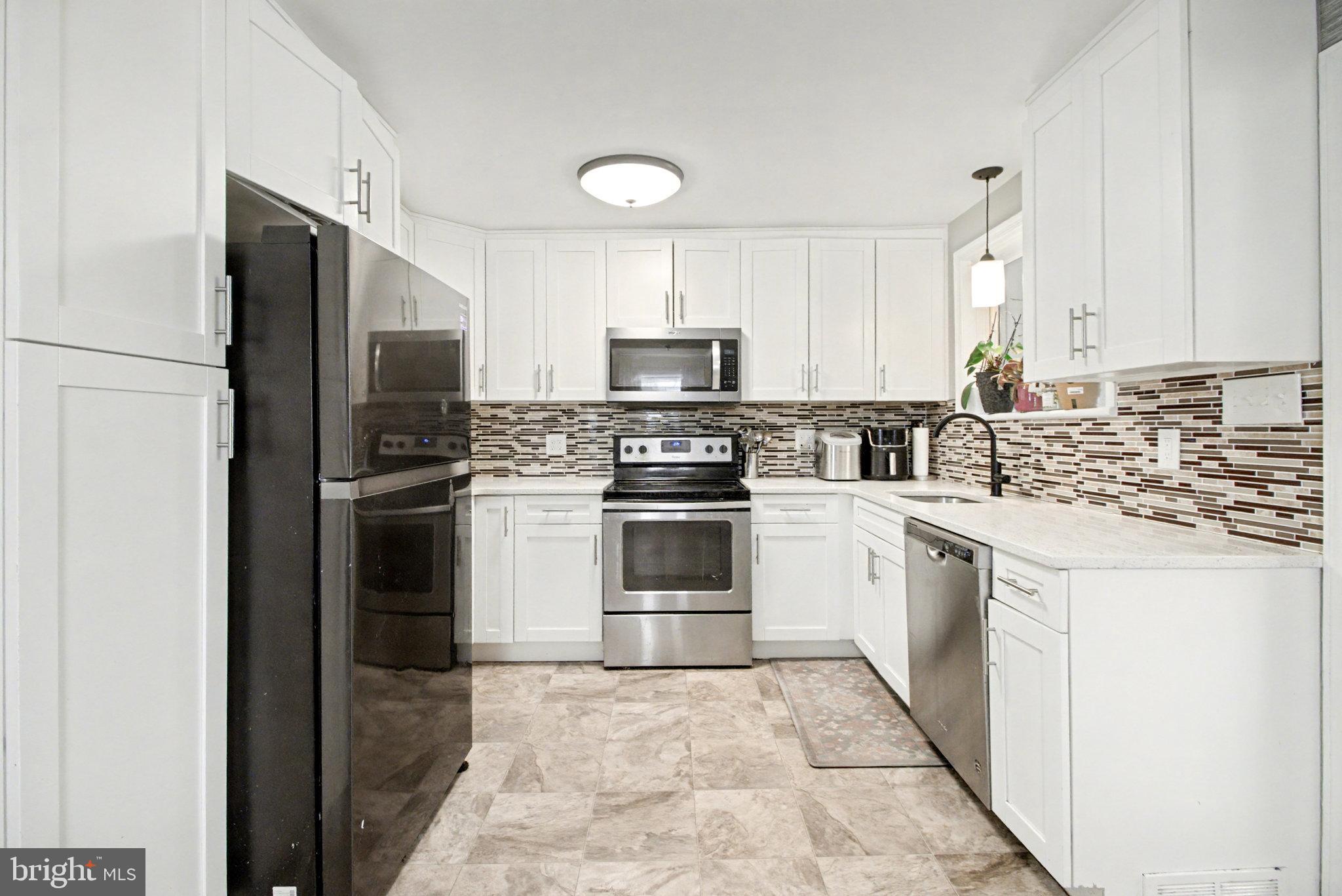 1310 Goldenville Road Gettysburg, PA 17325 - Photo 6 of 29 a kitchen with a stove a sink and a refrigerator