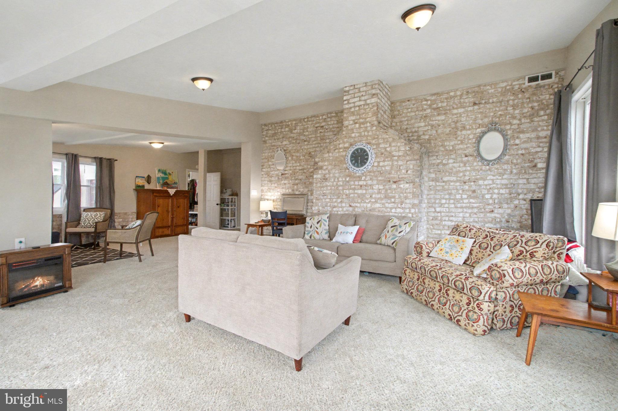1310 Goldenville Road Gettysburg, PA 17325 - Photo 9 of 29 a living room with furniture and a fireplace