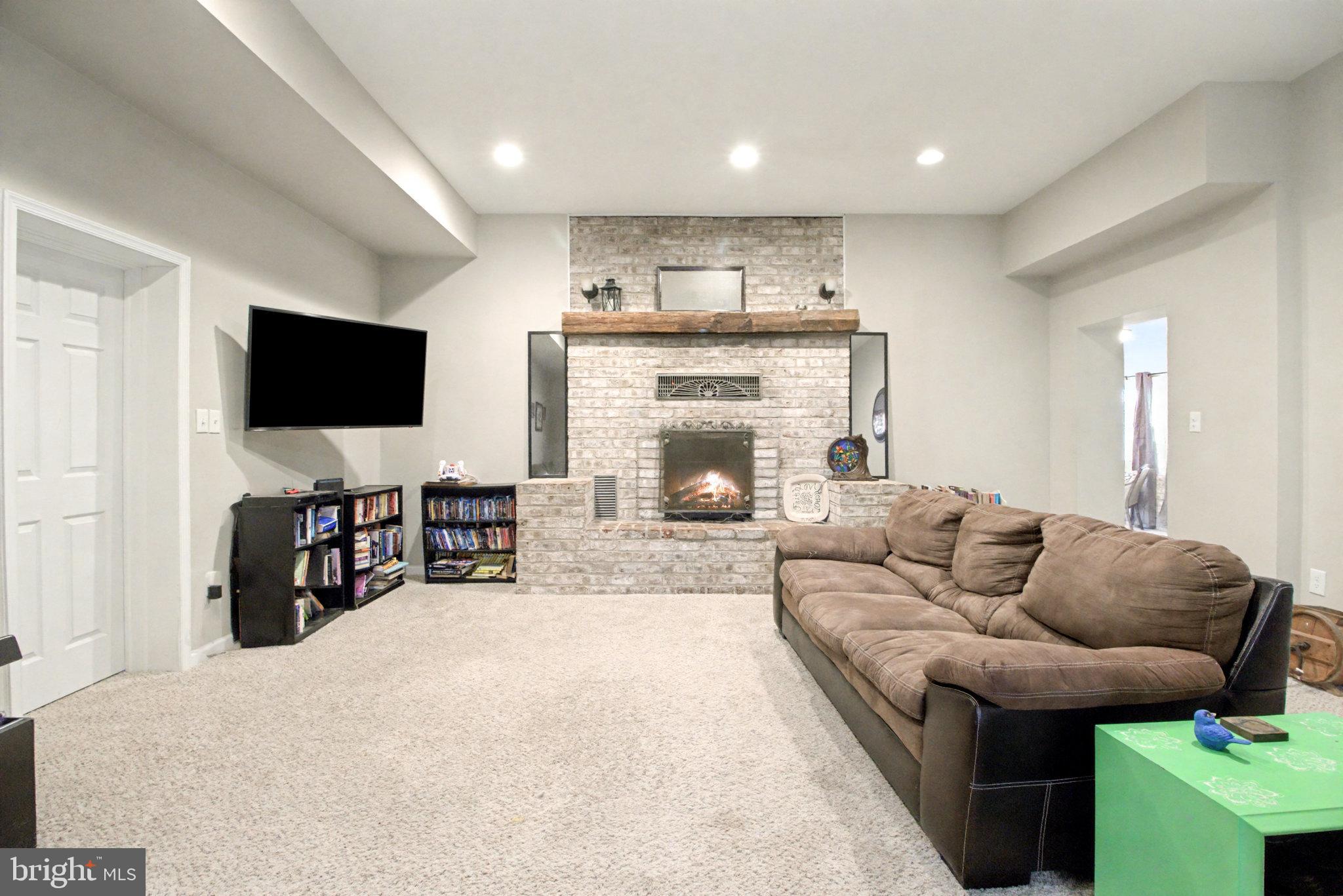 1310 Goldenville Road Gettysburg, PA 17325 - Photo 10 of 29 a living room with furniture and a flat screen tv with kitchen view