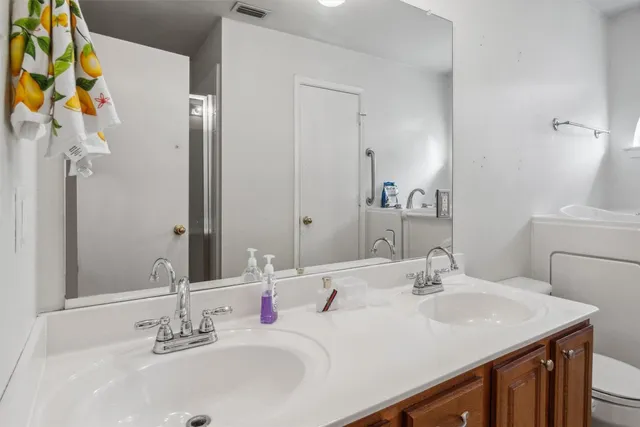 a bathroom with a sink vanity and a mirror
