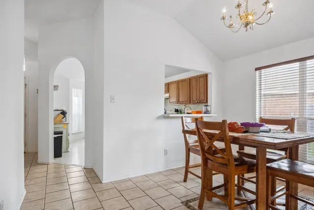 a view of a dining room with furniture and a chandelier