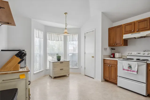 a kitchen with stainless steel appliances granite countertop a stove and a refrigerator