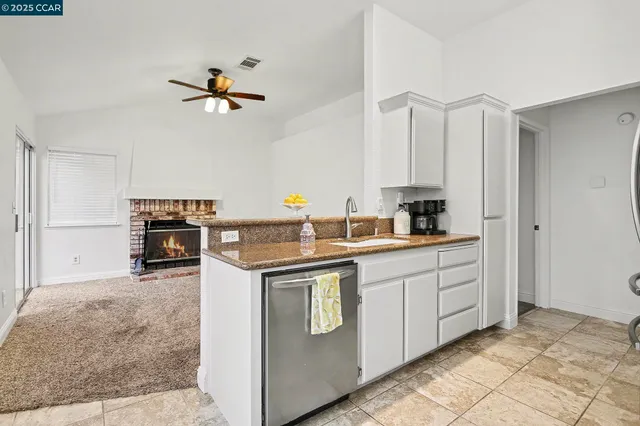 a kitchen with stainless steel appliances granite countertop a refrigerator and a stove
