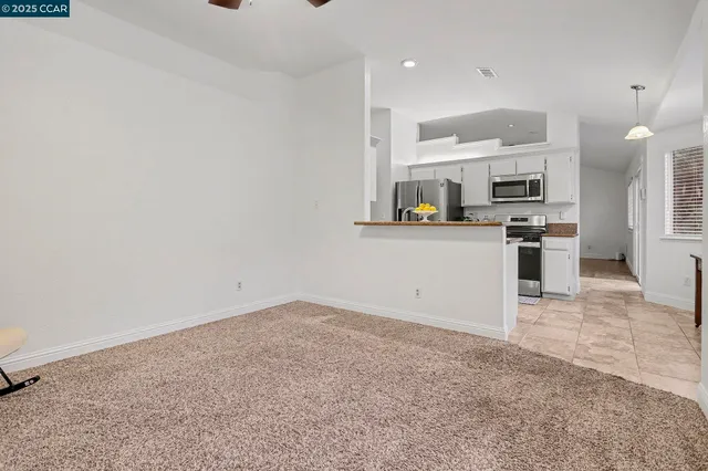 a kitchen with a refrigerator and a stove top oven