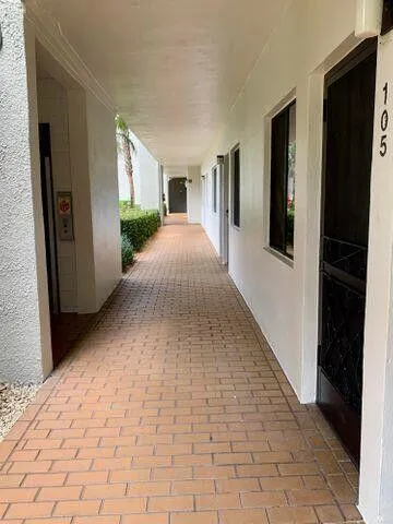 a view of a garden with a building in the background