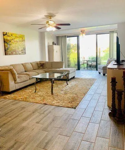 a living room with furniture and a floor to ceiling window