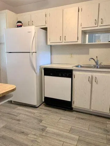 a white refrigerator freezer sitting inside of a kitchen