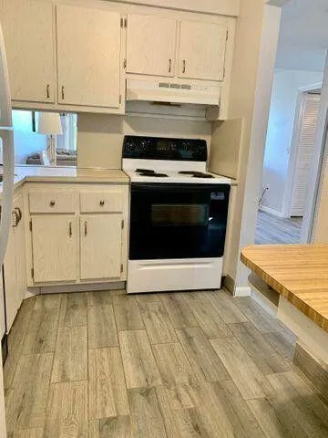 a view of kitchen with granite countertop cabinets and a stove top oven