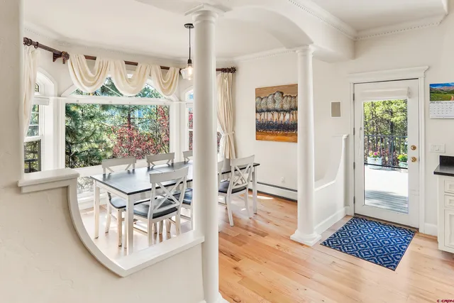 a view of a dining room with furniture wooden floor and a chandelier