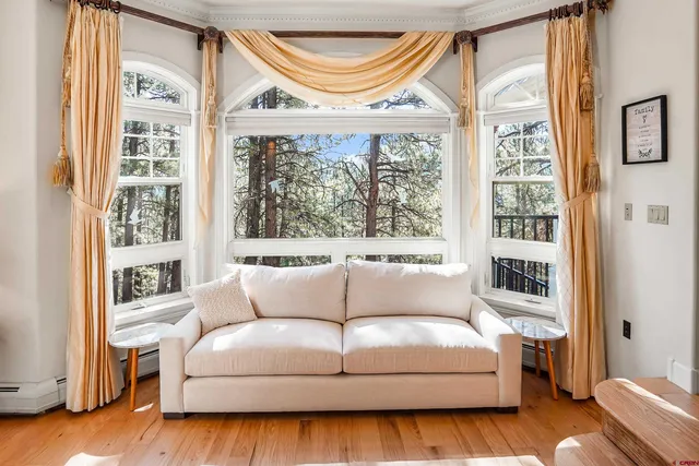 a living room with furniture a window and a fireplace