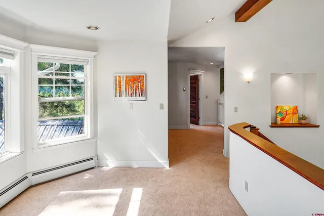 a hallway with furniture and book shelf