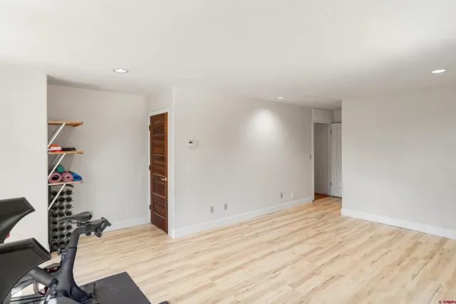 a view of a livingroom with wooden floor and furniture