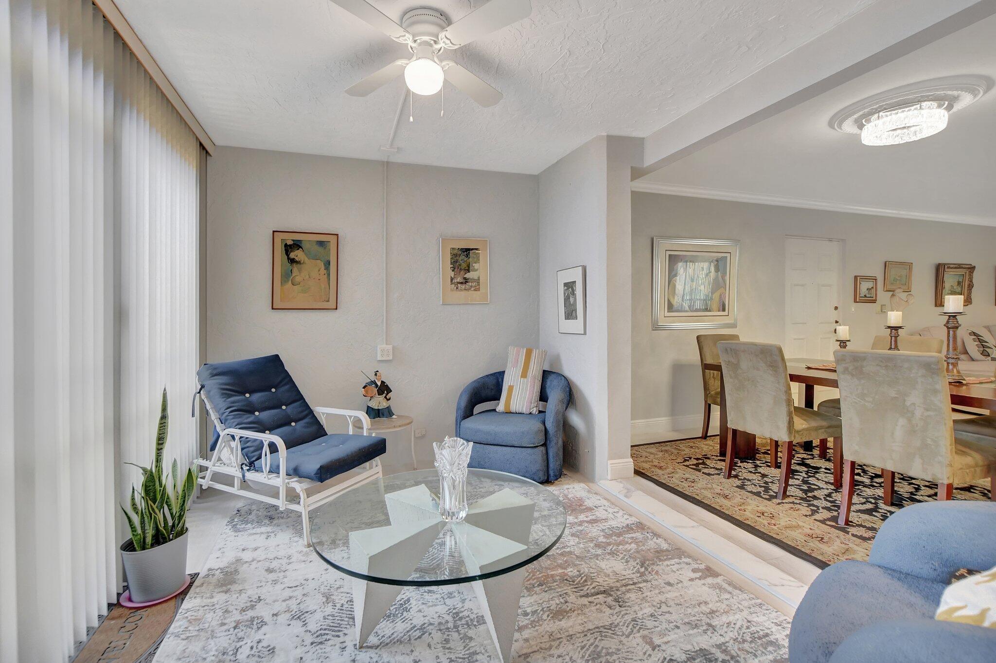 7194 Promenade Drive, Unit 102 Boca Raton, FL 33433 - Photo 12 of 56 a living room with furniture and wooden floor