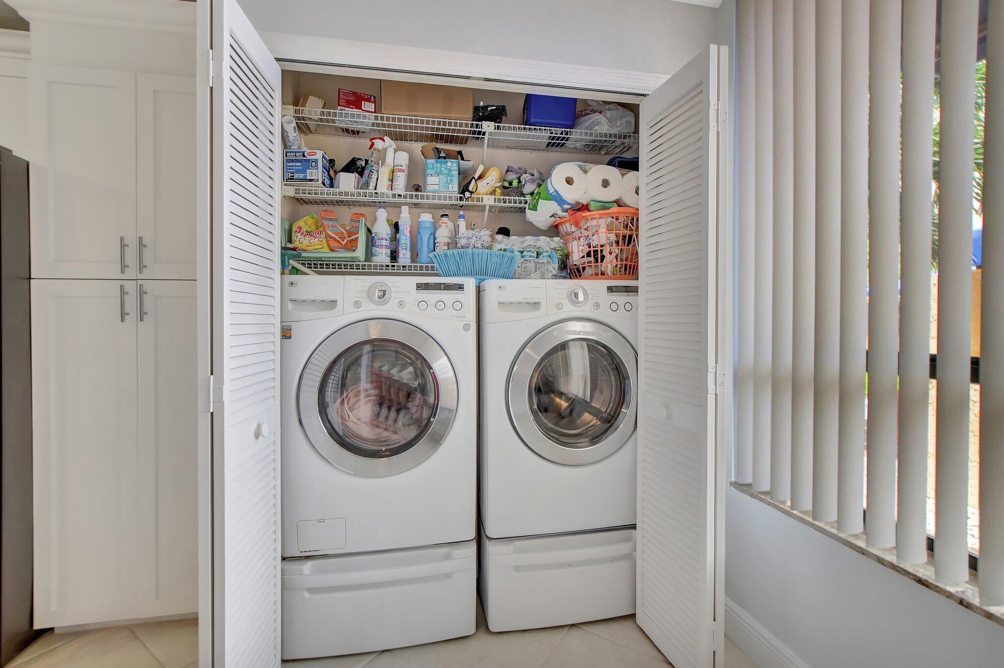7194 Promenade Drive, Unit 102 Boca Raton, FL 33433 - Photo 14 of 56 a view of walk in closet with clothes and shoes