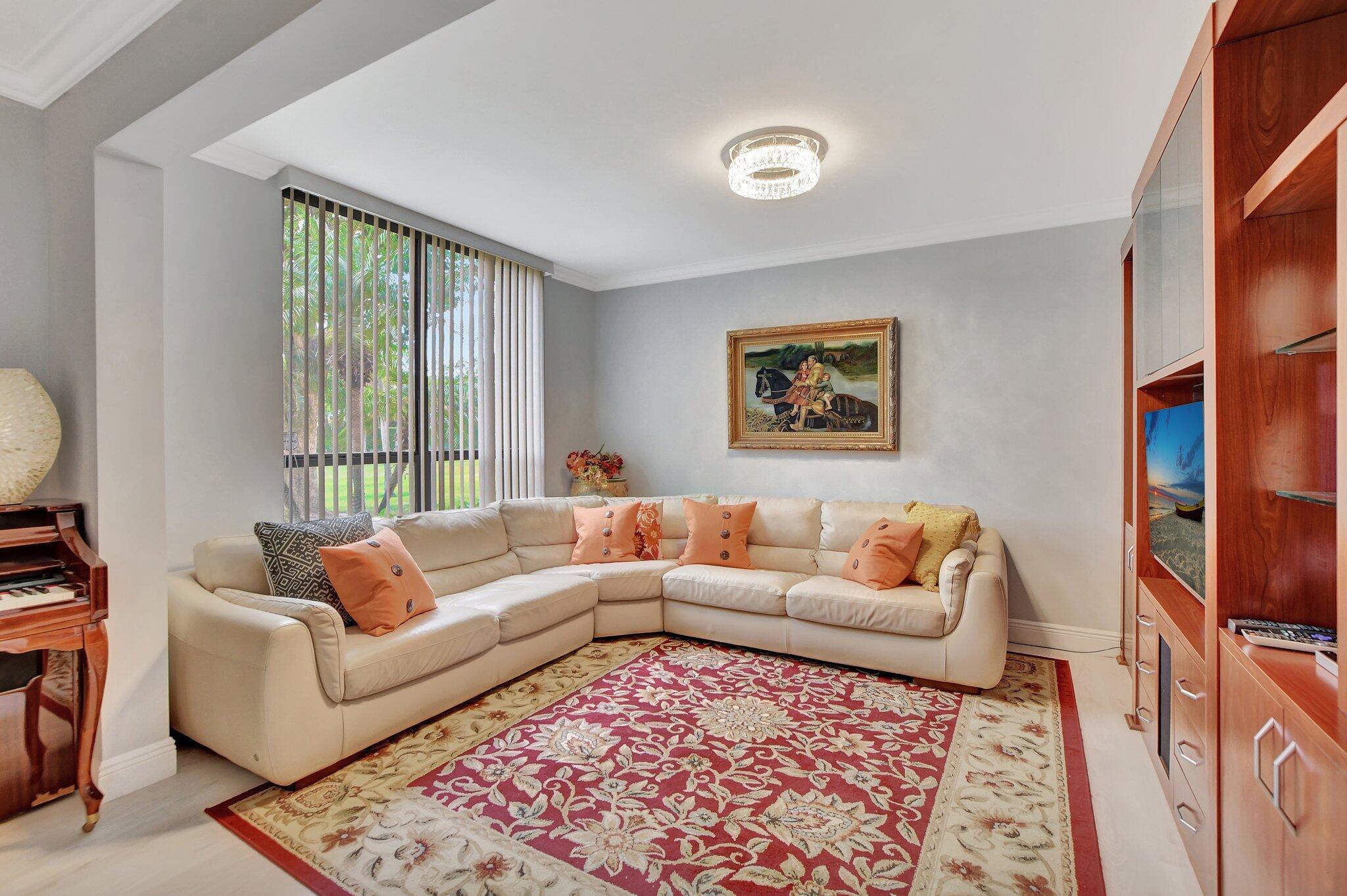7194 Promenade Drive, Unit 102 Boca Raton, FL 33433 - Photo 17 of 56 a living room with furniture and a rug