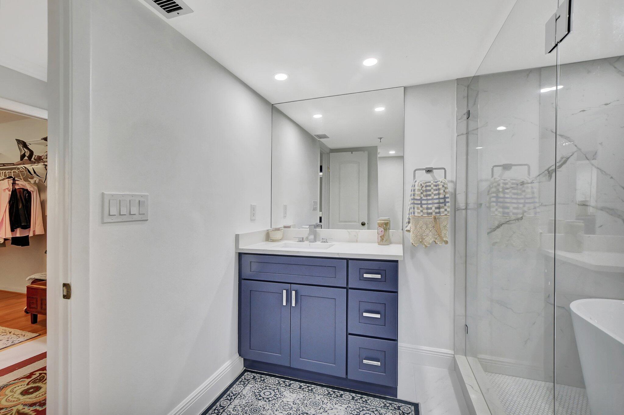 7194 Promenade Drive, Unit 102 Boca Raton, FL 33433 - Photo 30 of 56 a bathroom with a sink a toilet and shower