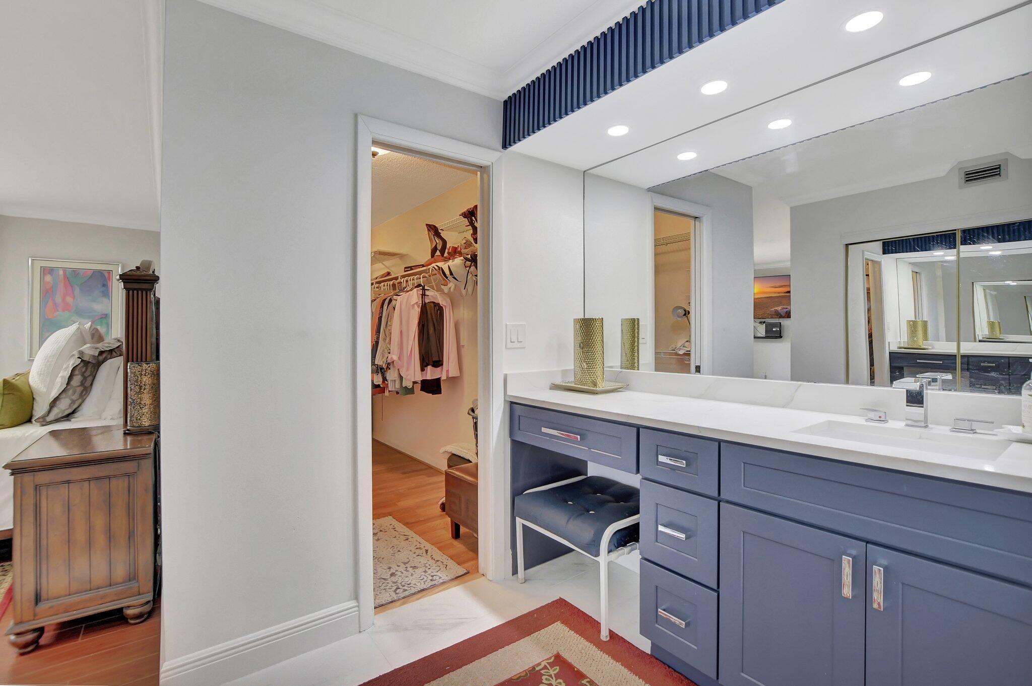 7194 Promenade Drive, Unit 102 Boca Raton, FL 33433 - Photo 31 of 56 a bathroom with a sink a mirror and a shower