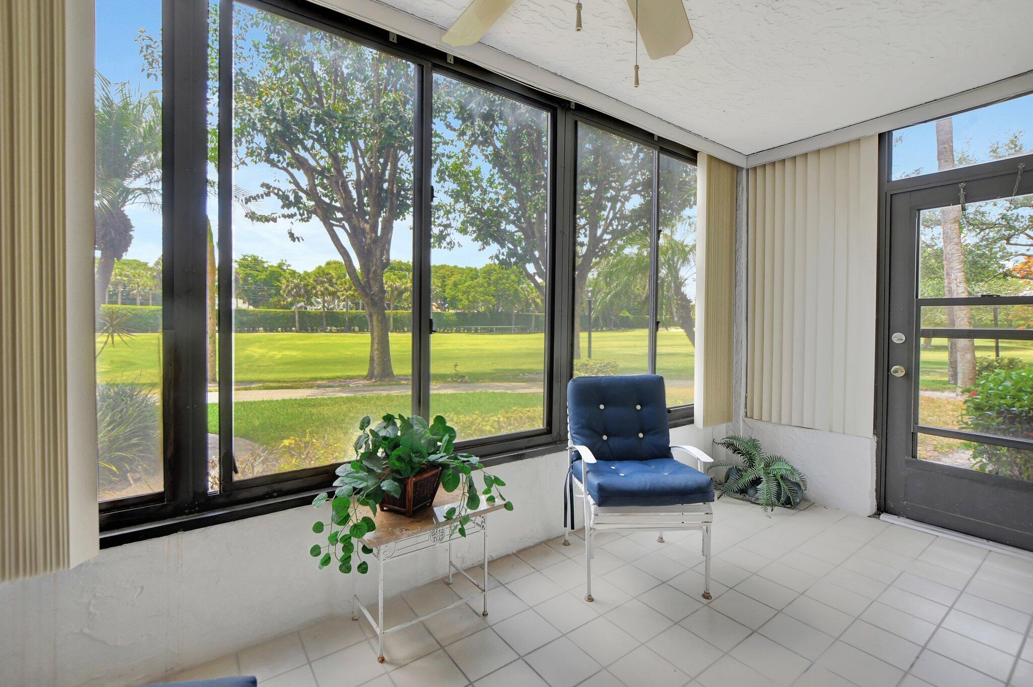 7194 Promenade Drive, Unit 102 Boca Raton, FL 33433 - Photo 35 of 56 a living room with furniture and floor to ceiling windows