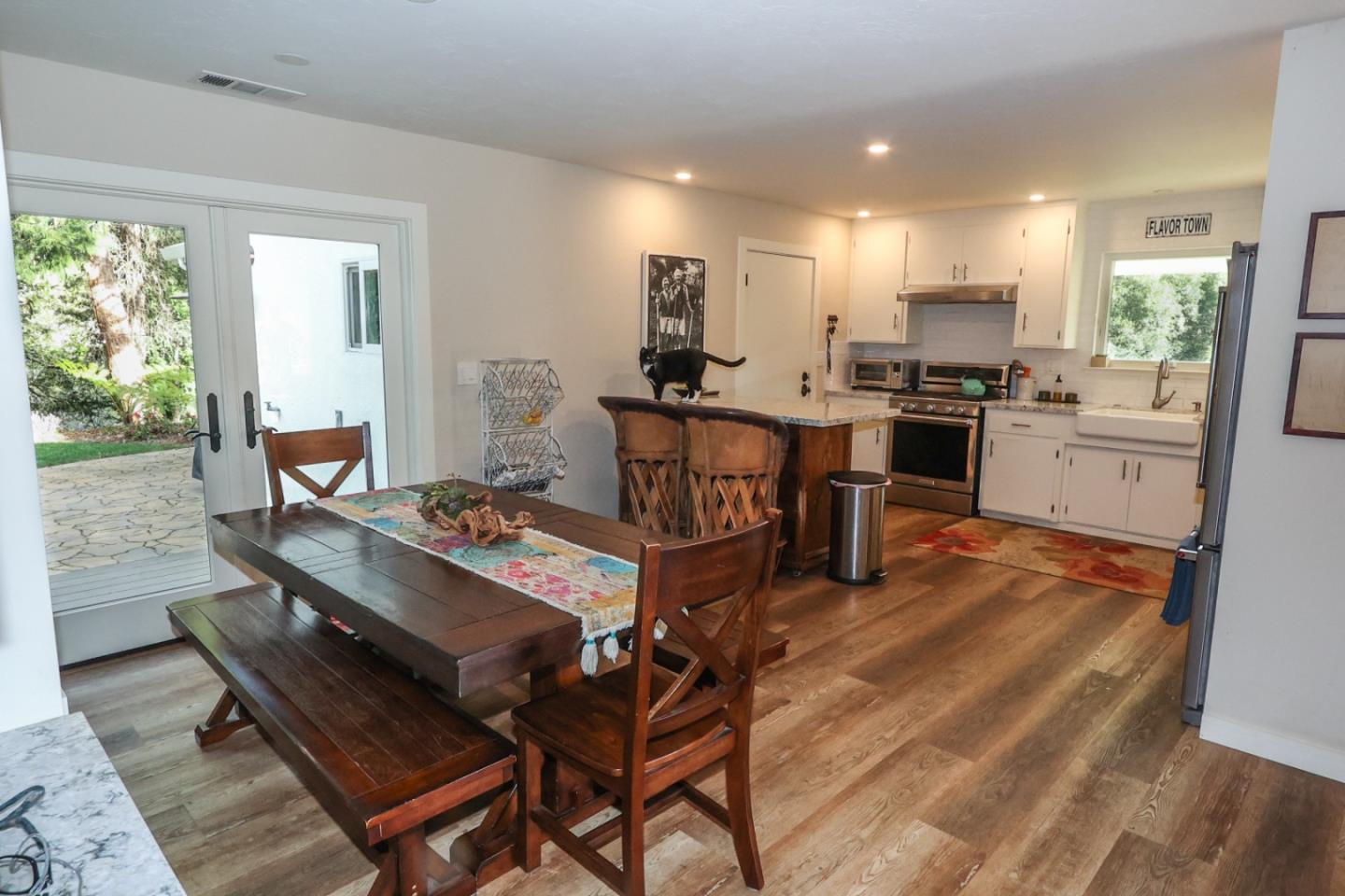 3247 Soquel San Jose Road Soquel, CA 95073 - Photo 7 of 34 a living room with furniture a dining table wooden floor and a large window
