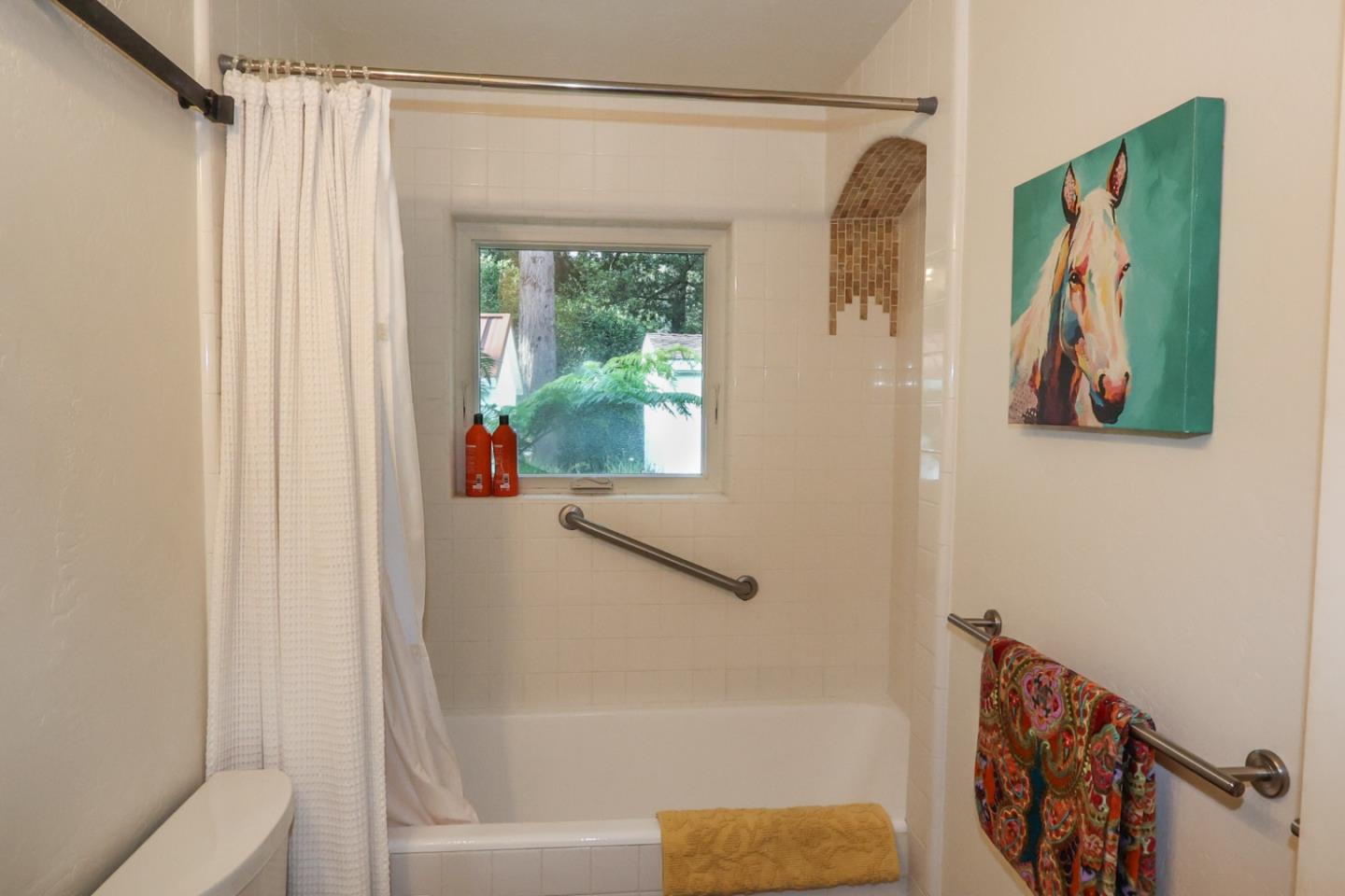 3247 Soquel San Jose Road Soquel, CA 95073 - Photo 10 of 34 a bathroom with a shower curtain and a window