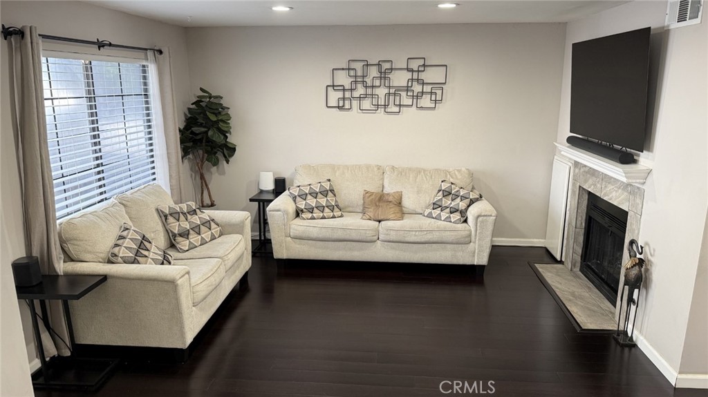 a living room with furniture fireplace and flat screen tv