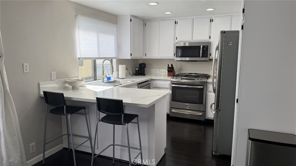 11300 Foothill Boulevard, Unit 33 Lakeview Terrace, CA 91342 - Photo 4 of 19 a kitchen with a sink cabinets and stainless steel appliances