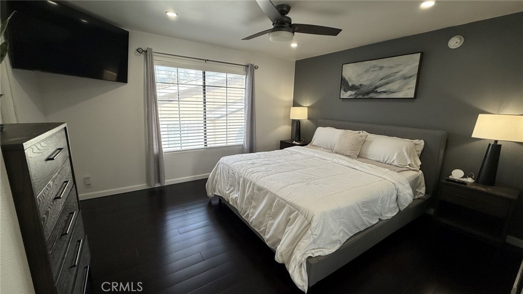 11300 Foothill Boulevard, Unit 33 Lakeview Terrace, CA 91342 - Photo 6 of 19 a bedroom with a bed and a flat tv screen on the dresser