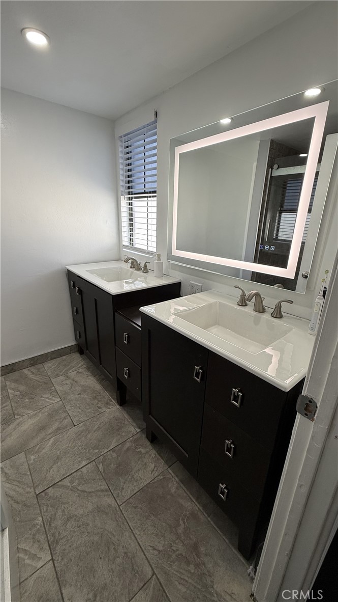11300 Foothill Boulevard, Unit 33 Lakeview Terrace, CA 91342 - Photo 8 of 19 a spacious bathroom with a sink vanity and mirror