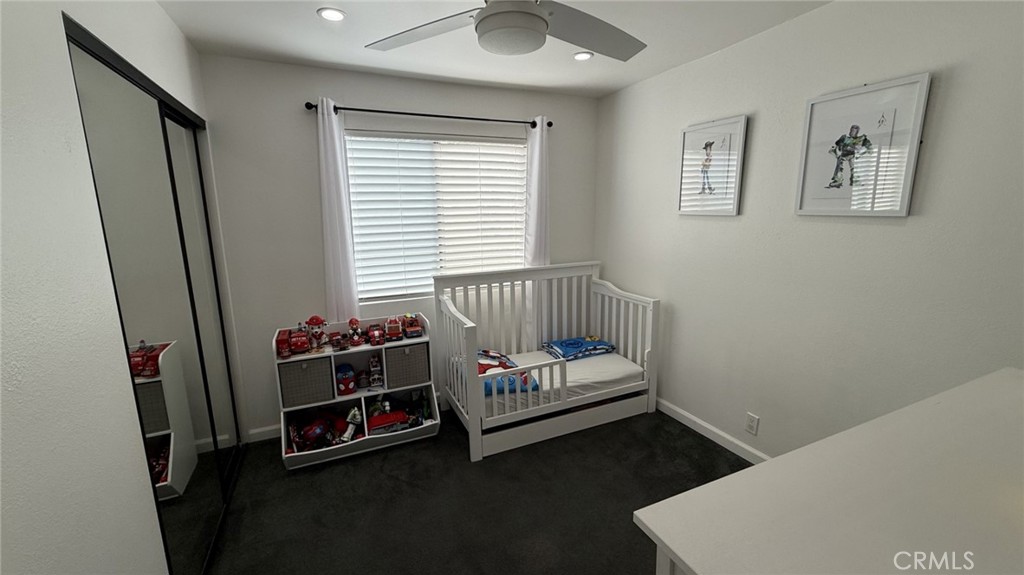 11300 Foothill Boulevard, Unit 33 Lakeview Terrace, CA 91342 - Photo 9 of 19 a bedroom with furniture and a window