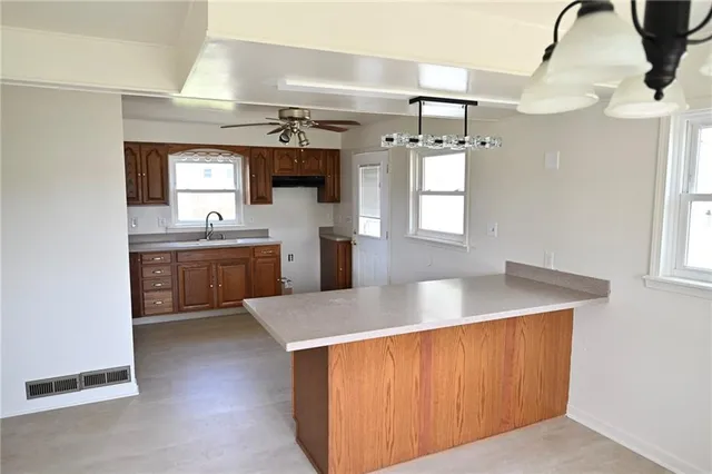 a kitchen with a sink a stove and cabinets
