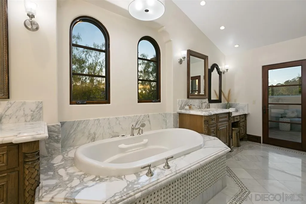 7620 Iluminado San Diego, CA 92127 - Photo 15 of 25 a spacious bathroom with a double vanity sink and a mirror