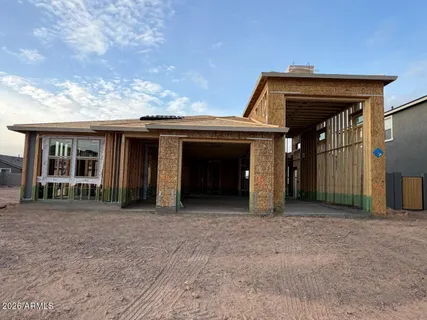 a view of an house with backyard and a porch