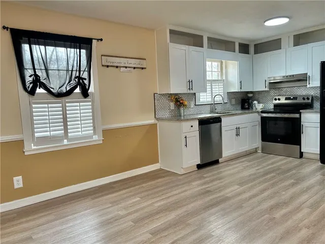 a kitchen with a sink cabinets and window