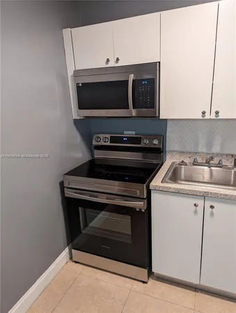 a kitchen with a stove and a microwave