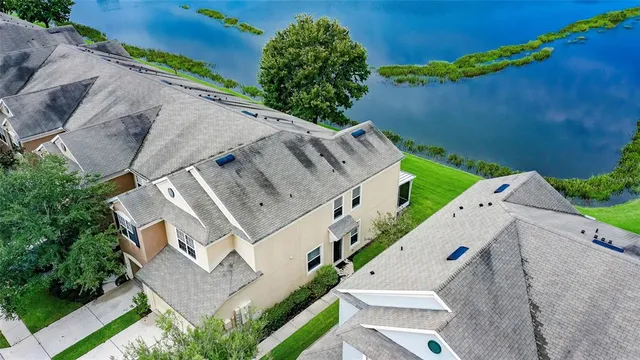 an aerial view of a house with a yard