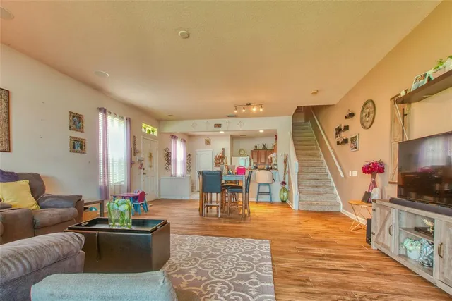 a living room with furniture and wooden floor