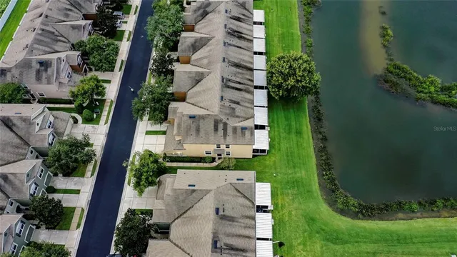 an aerial view of a house with a yard