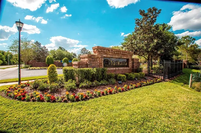 a view of a house with a yard and sitting area