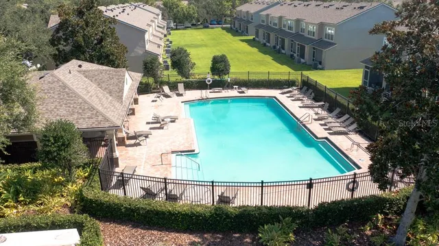 a view of a swimming pool with a patio and a garden