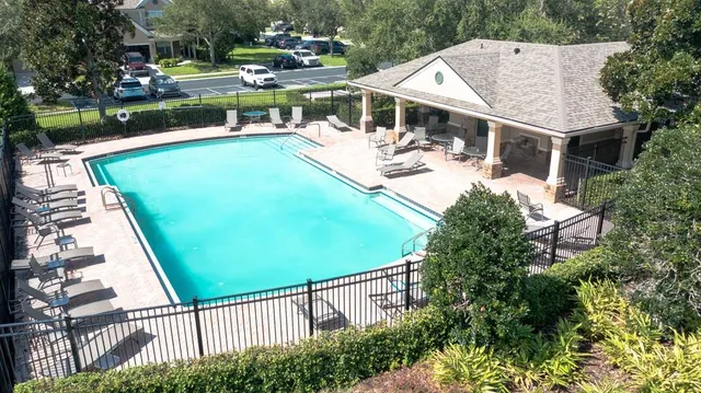 a view of a house with backyard and sitting area