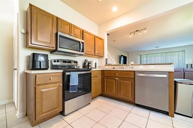 a kitchen with stainless steel appliances granite countertop a refrigerator stove and sink