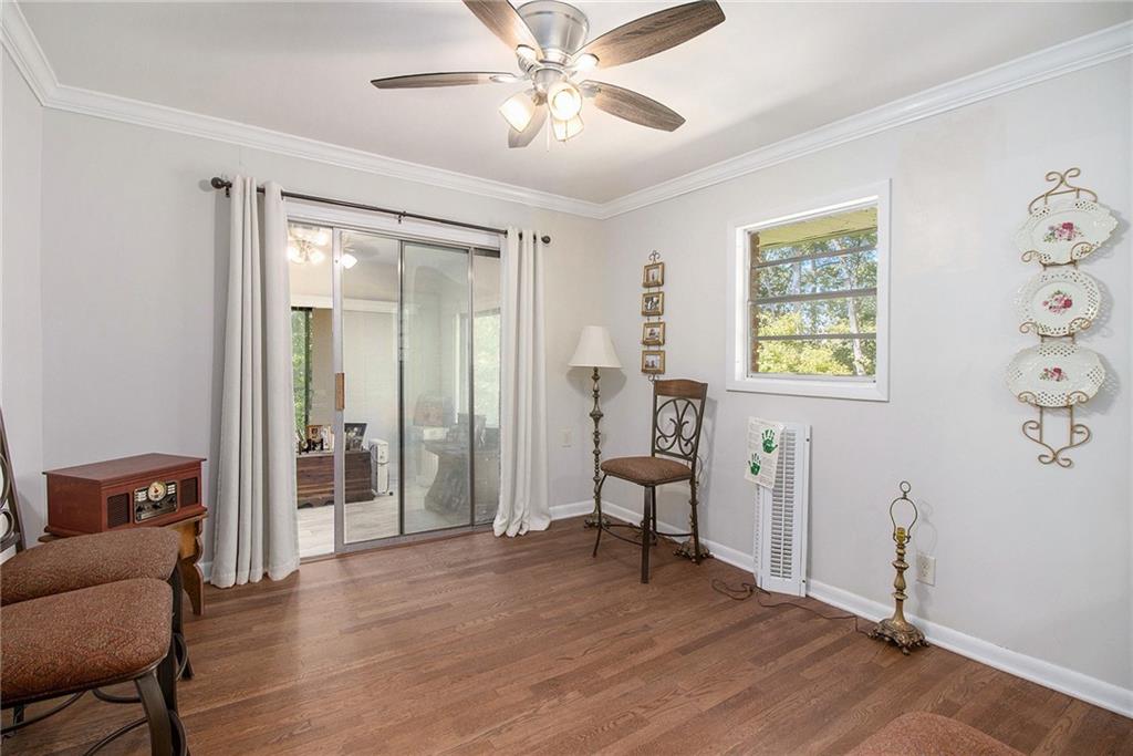 111 Lewis Drive Southeast Calhoun, GA 30701 - Photo 24 of 53 a view of a livingroom with wooden floor and a ceiling fan