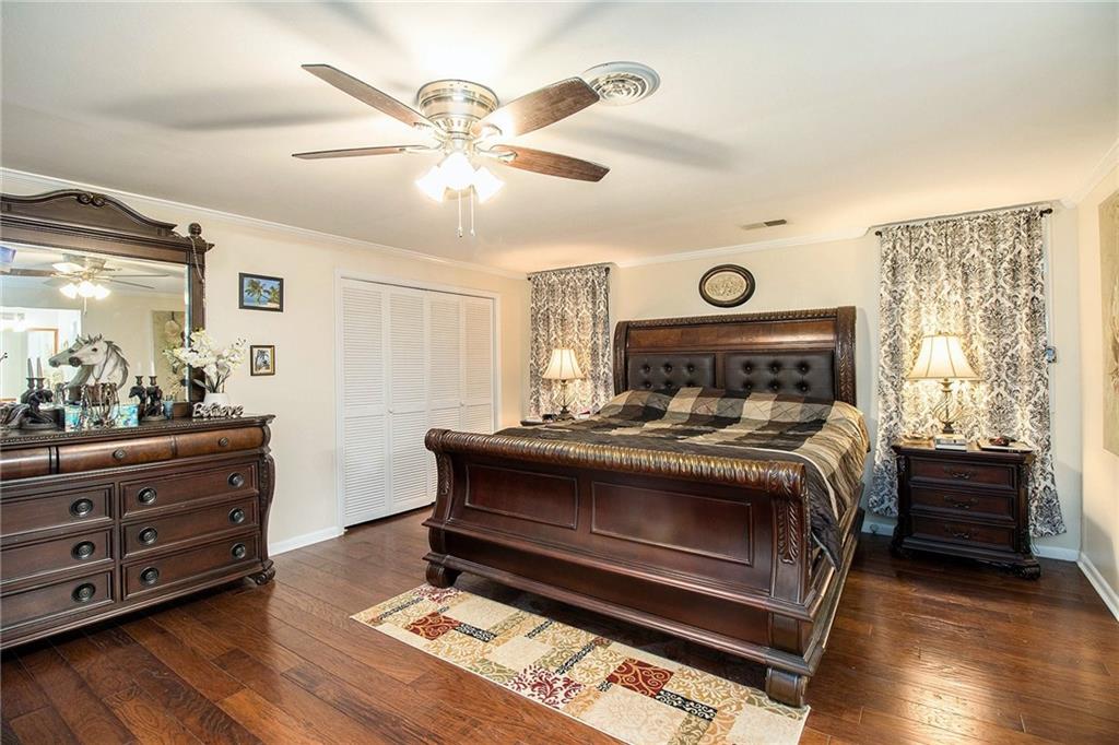 111 Lewis Drive Southeast Calhoun, GA 30701 - Photo 27 of 53 a bedroom with a bed and a chandelier