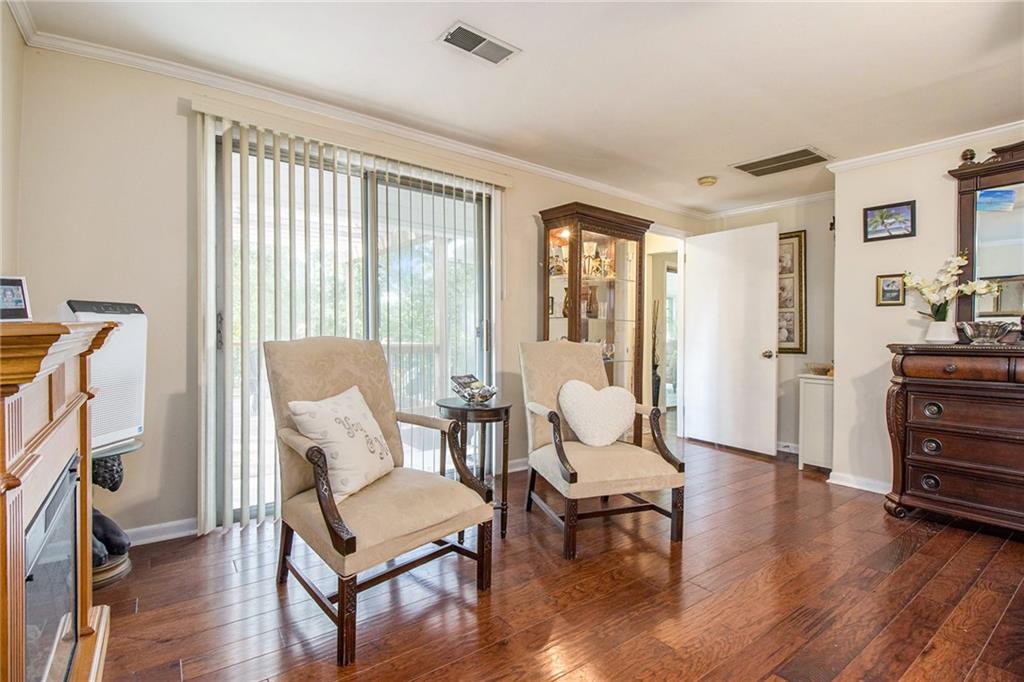 111 Lewis Drive Southeast Calhoun, GA 30701 - Photo 29 of 53 a living room with furniture a wooden floor and a large window