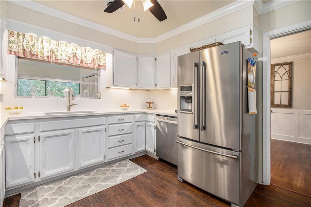 111 Lewis Drive Southeast Calhoun, GA 30701 - Photo 6 of 53 a kitchen with stainless steel appliances a refrigerator sink and cabinets