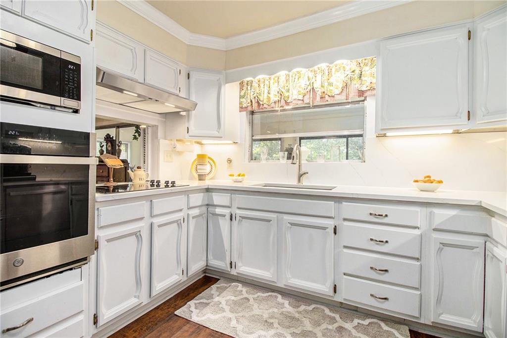 111 Lewis Drive Southeast Calhoun, GA 30701 - Photo 7 of 53 a kitchen with cabinets appliances and a window