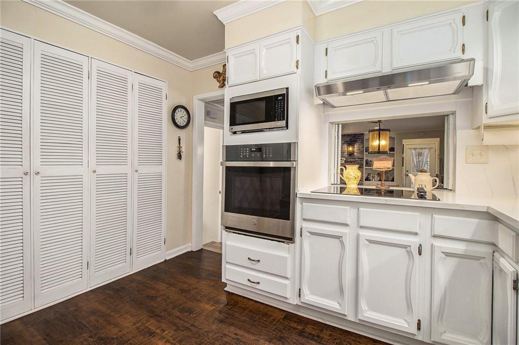 111 Lewis Drive Southeast Calhoun, GA 30701 - Photo 9 of 53 a kitchen with white cabinets and stainless steel appliances